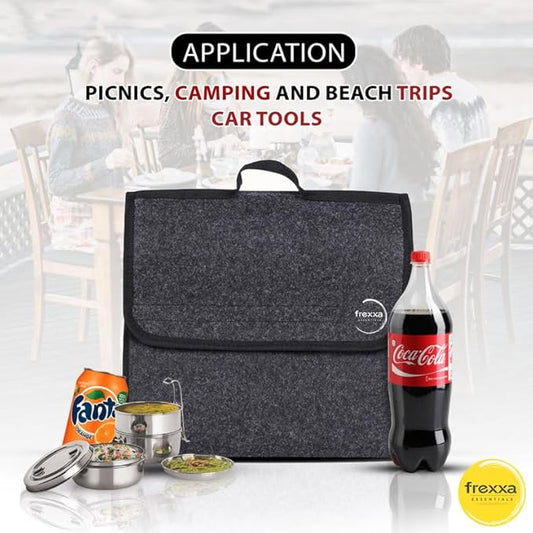 Gray cooler bag with picnic items and Coca-Cola bottle on a blurred background