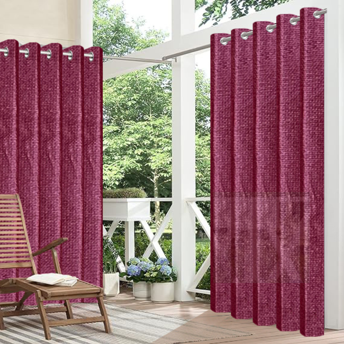 Red outdoor curtains with grommets on a patio with a chair and plants.