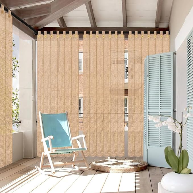 Beige outdoor curtain with a chair and plant in a sunroom setting