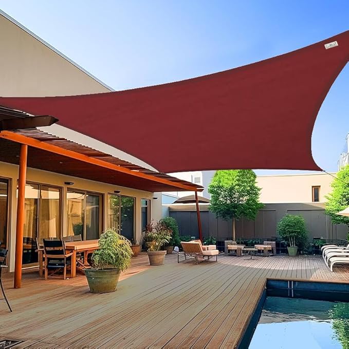 Red outdoor shade sail over a patio area with furniture and pool.