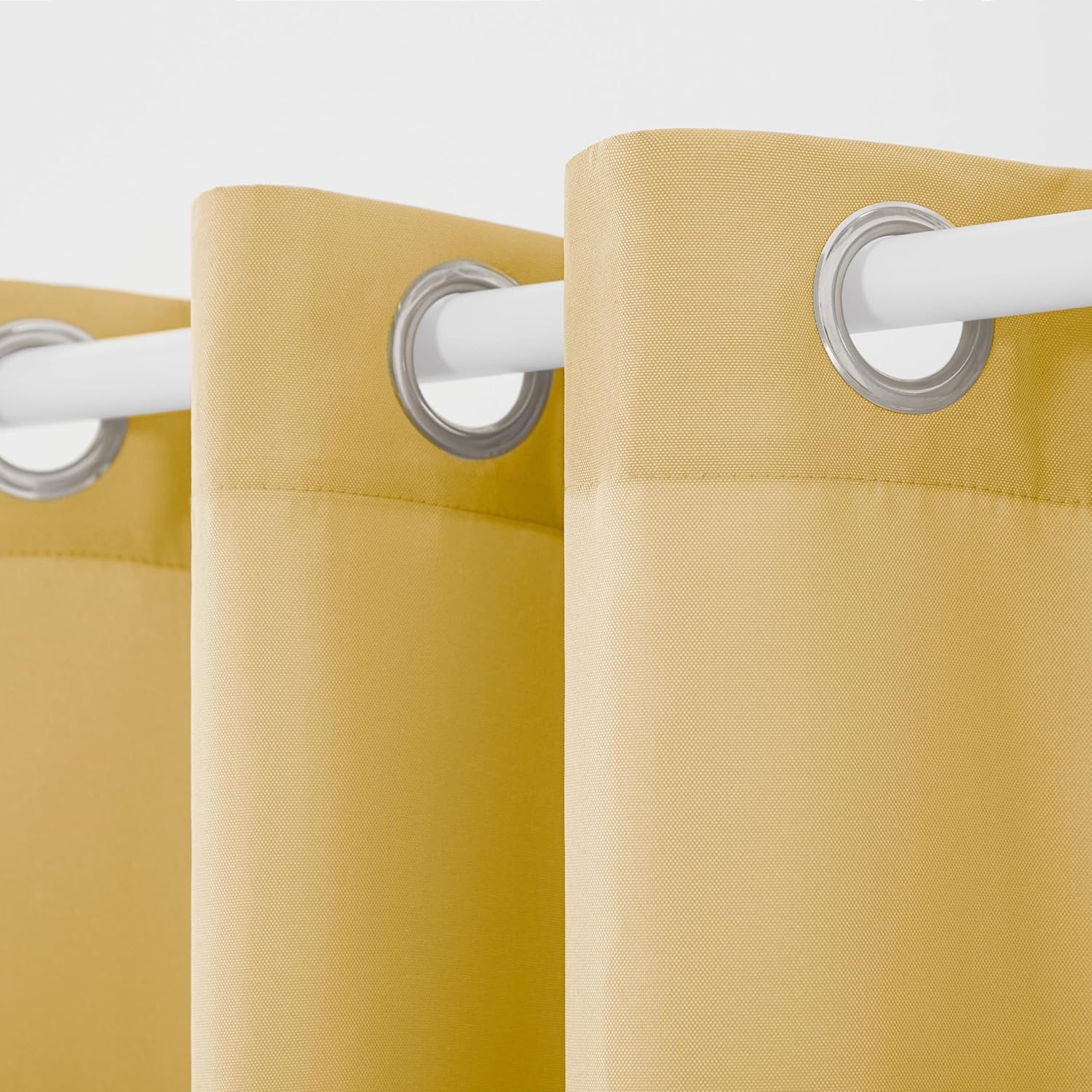 Yellow curtains with silver eyelets on a white background