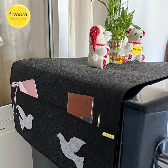 Black pet bed with decorative items on a surface, featuring the frexxa brand.