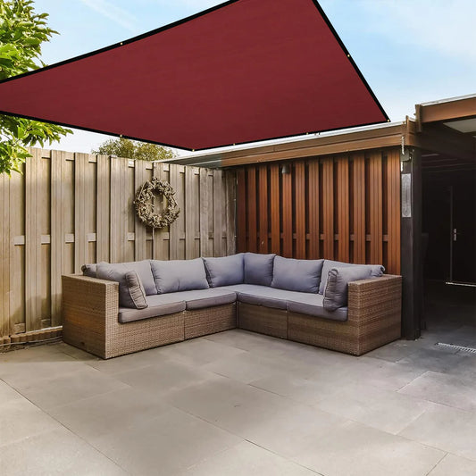 Outdoor patio with wicker sectional sofa under a red canopy