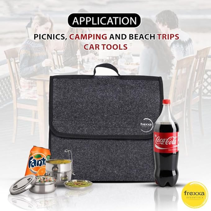 Gray cooler bag with picnic items and Coca-Cola bottle on a blurred background