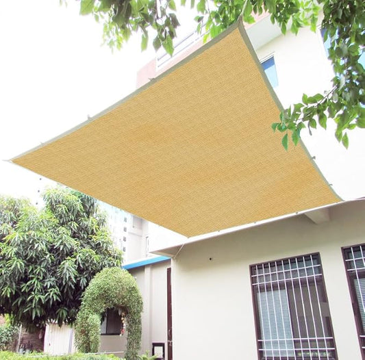 Beige sunshade on a house exterior with trees in the background