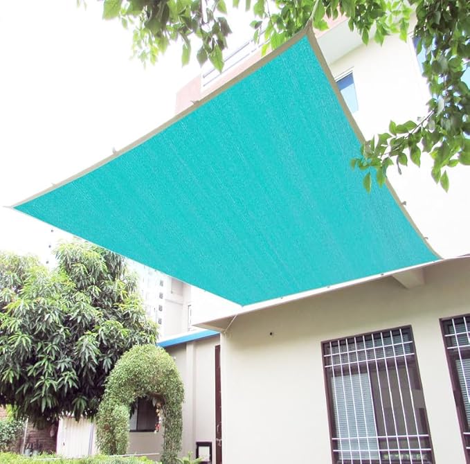Teal awning on a building with trees in the background