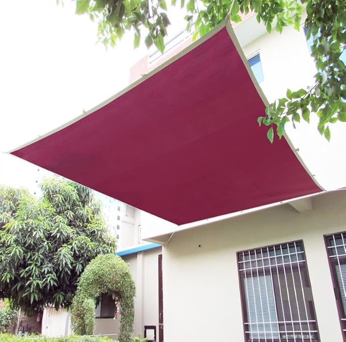 Maroon awning on a building with trees in the background