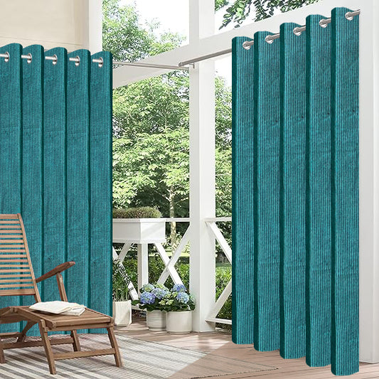 Teal outdoor curtains on a patio with a chair and plants.