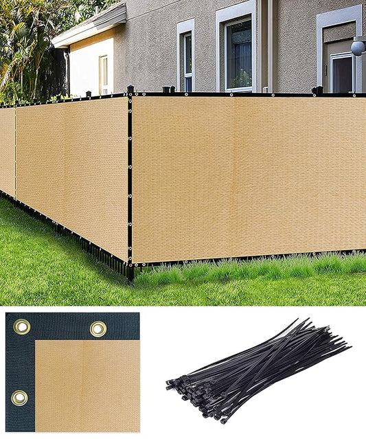 Beige privacy screen fence with black ties on a grassy area in front of a house.