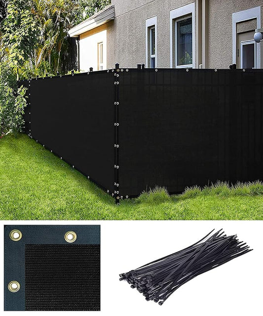 Black privacy fence screen with grommets and ties on a grassy area with a house in the background.