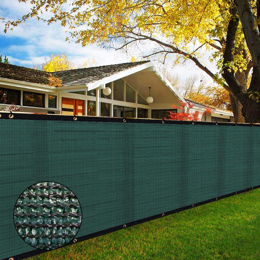 Green privacy screen with detailed texture overlay in front of a house with a tree in the background.