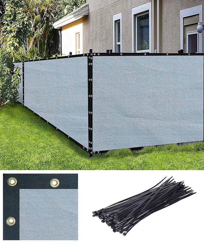 Privacy screen fence with installation hardware on a grassy area.