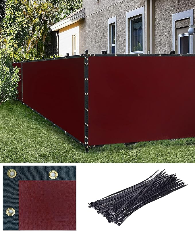 Red privacy screen with black ties in front of a house
