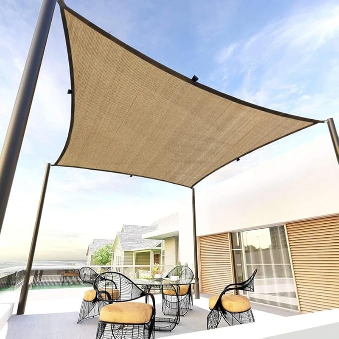 Beige outdoor canopy providing shade over a patio area with chairs and a table.
