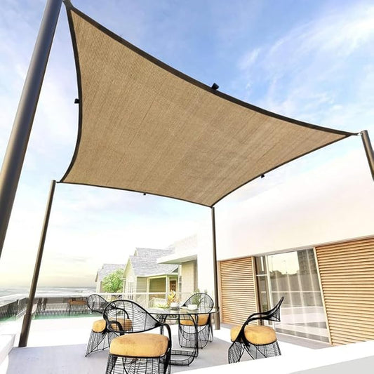 Beige outdoor canopy providing shade over a patio area with chairs and a table.