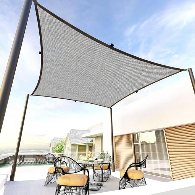 Outdoor patio with a large shade sail over a dining area