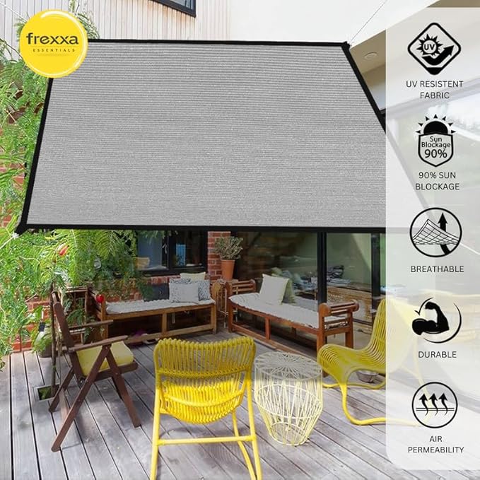 Outdoor patio with a frexxa sun shade, yellow chairs, and a deck area.