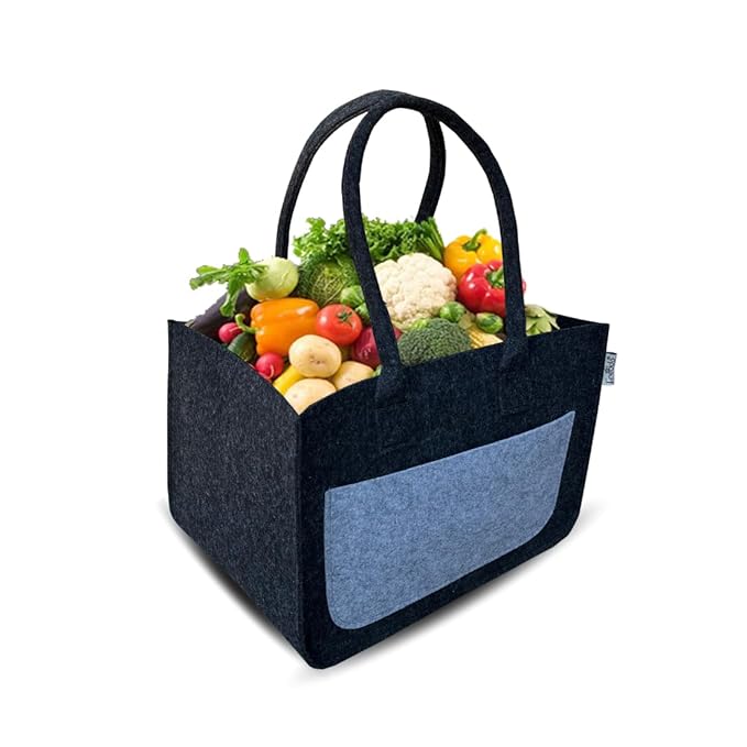 Black tote bag with blue pocket filled with groceries on a white background